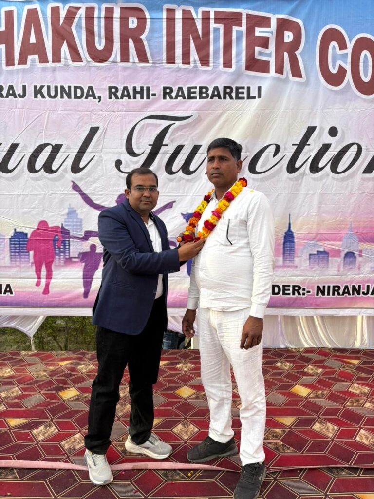 Principal Abhishek Srivastava placing a marigold garland around a guest in a white kurta on the Annual Function stage.
