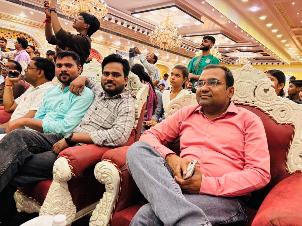 Staff, students and guests seated in the decorated hall watching the Annual Function programme.