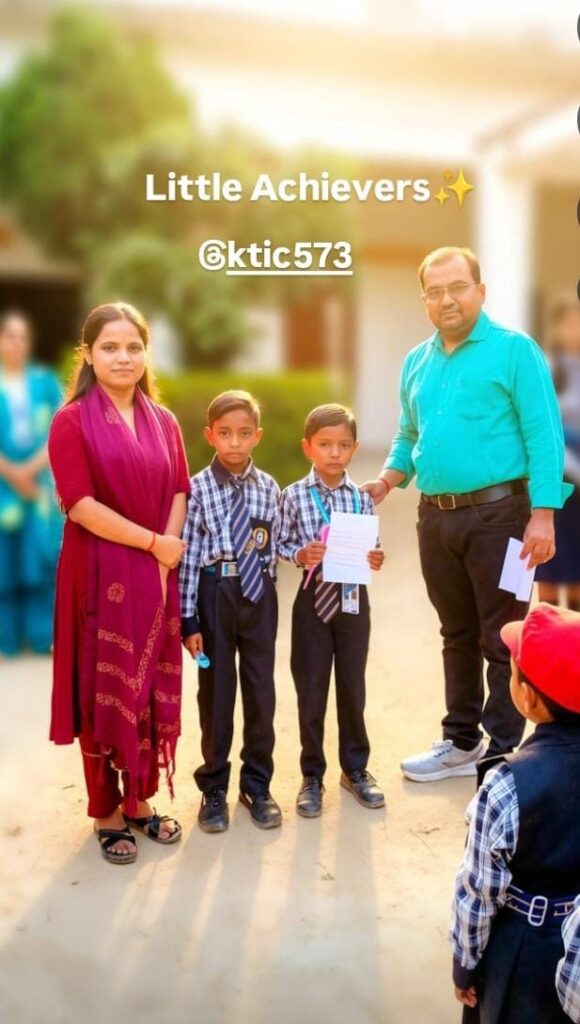 Principal Abhishek Srivastava and a teacher standing with two young prize-winners from the primary section, captioned Little Achievers.