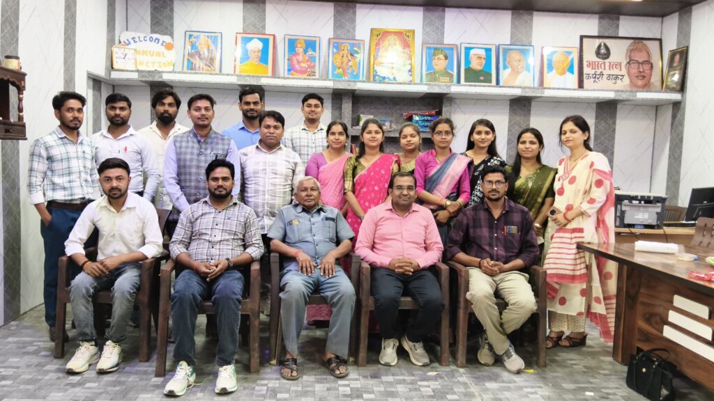 Teaching and administrative staff of Karpoori Thakur Intermediate College seated and standing for a group photograph in the college hall