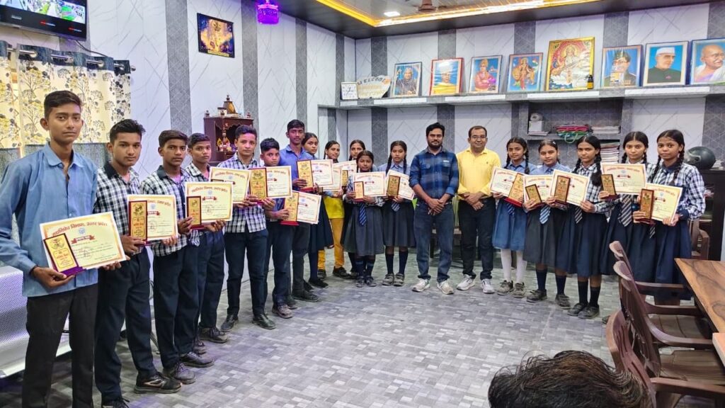 Students in uniform holding merit certificates with two teachers in the college office