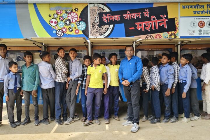 Students queuing along the open display panels of the Department of Science and Technology mobile science exhibition van on the theme Machines in Daily Life