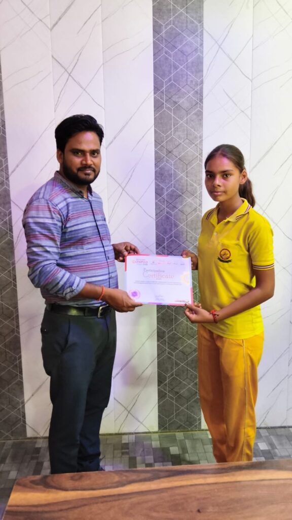 Manager Hariom Sharma presenting a certificate to a student wearing the college's yellow sports uniform.