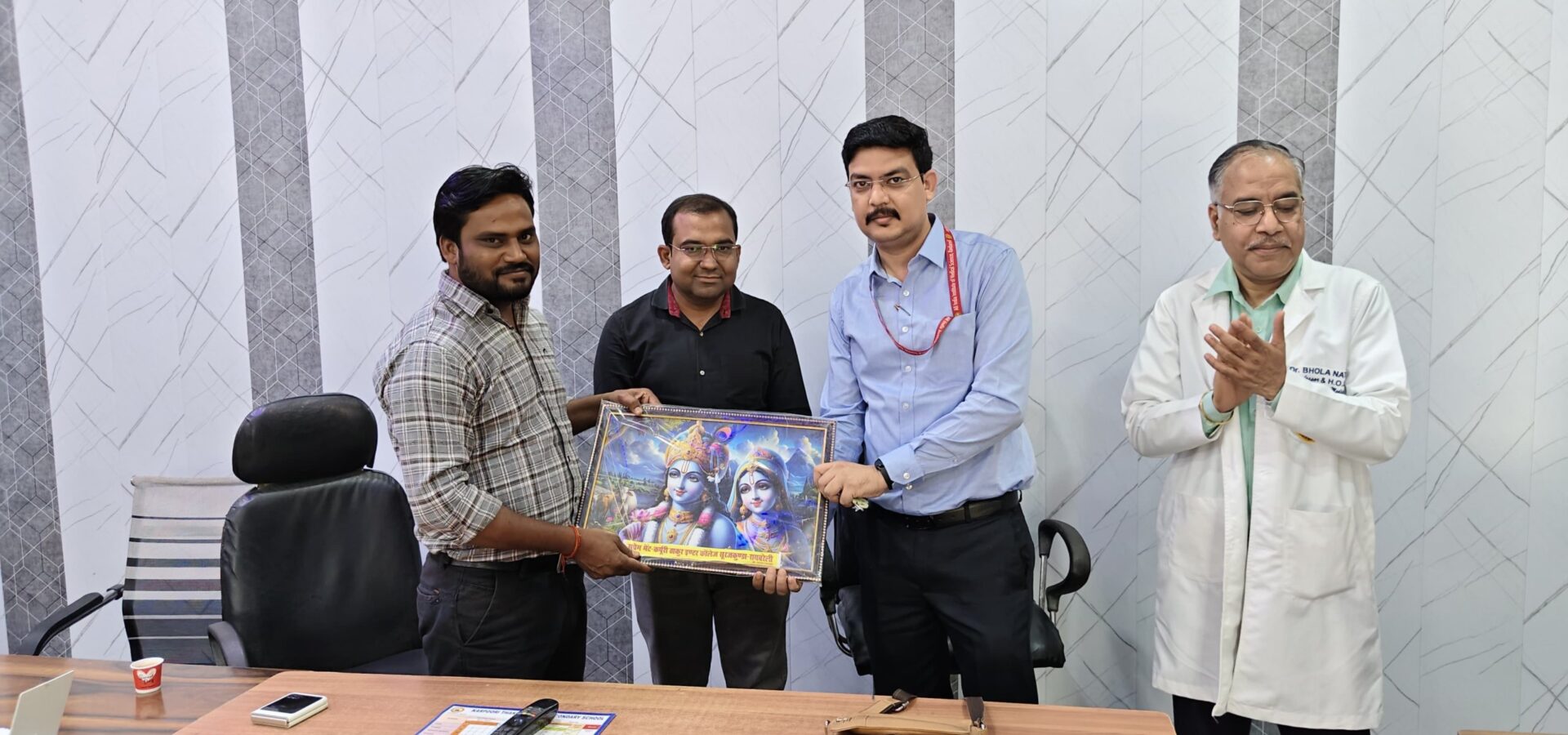 School staff presenting a framed memento to a visiting doctor after the World TB Day awareness programme